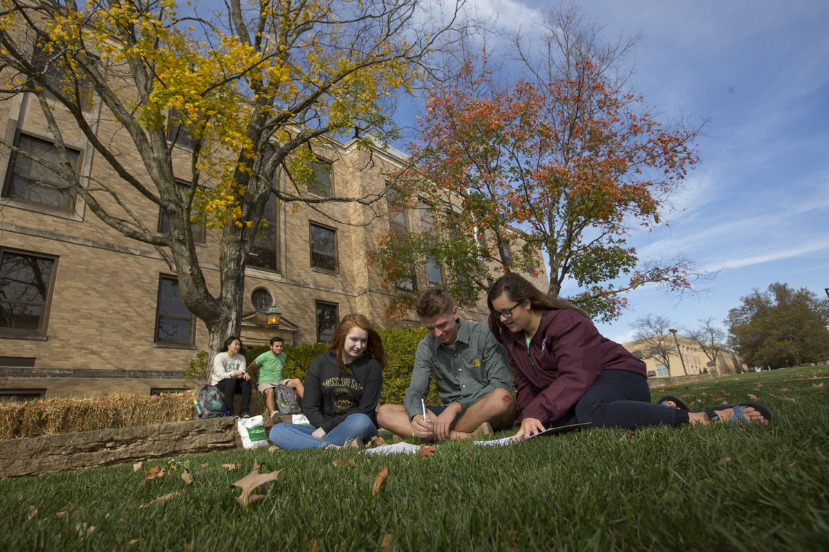 Students studying outside on campus