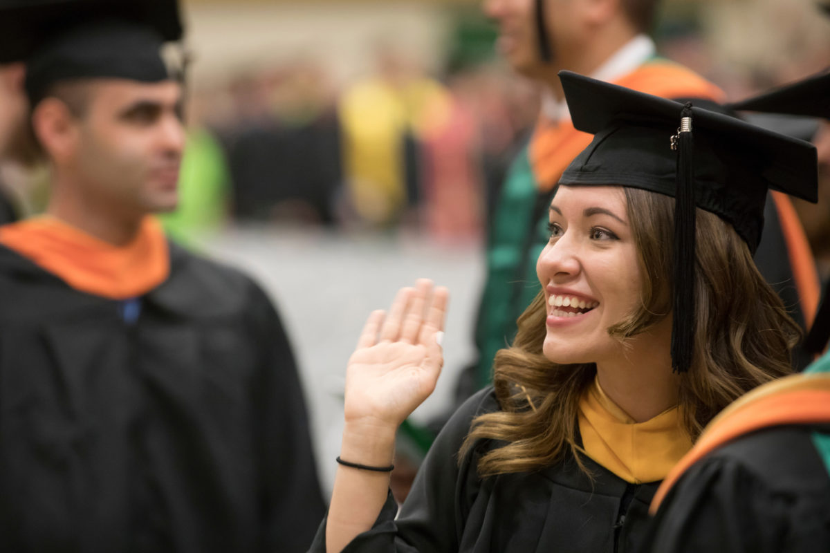 Graduate waving