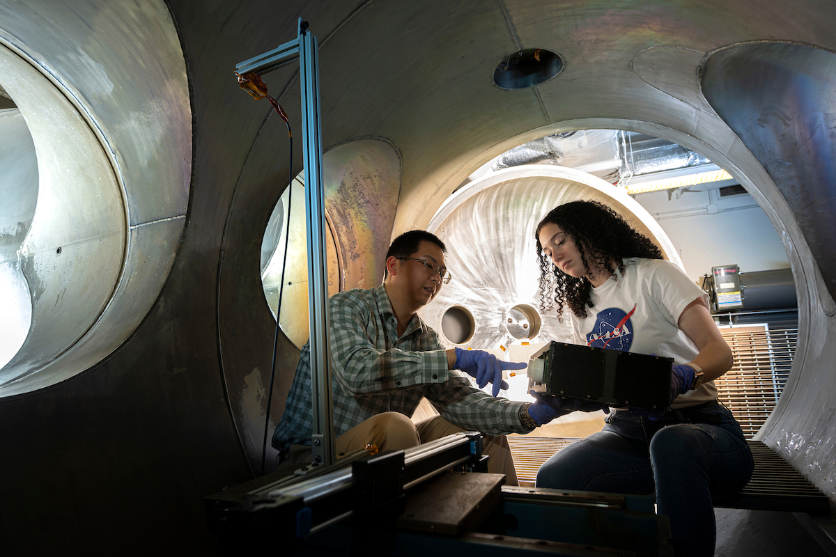 Frank Han and student in plasma vacuum chamber