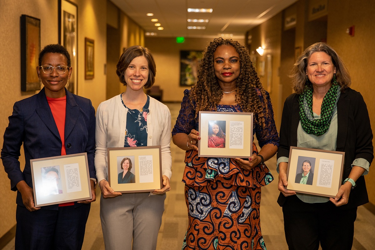 Four women holding awards