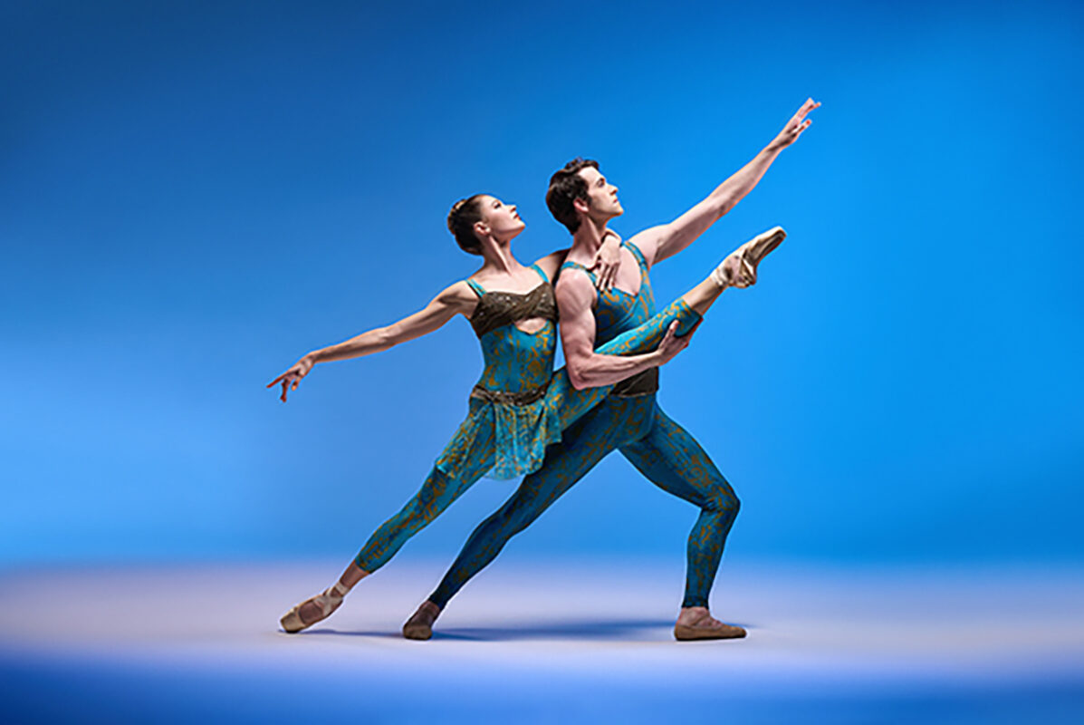 Two ballet dancers with blue background.