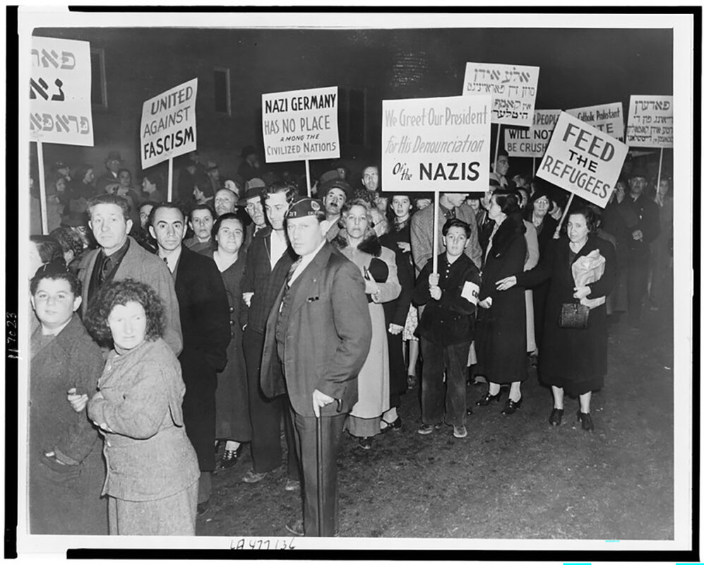 Photo of people protesting holding signs.