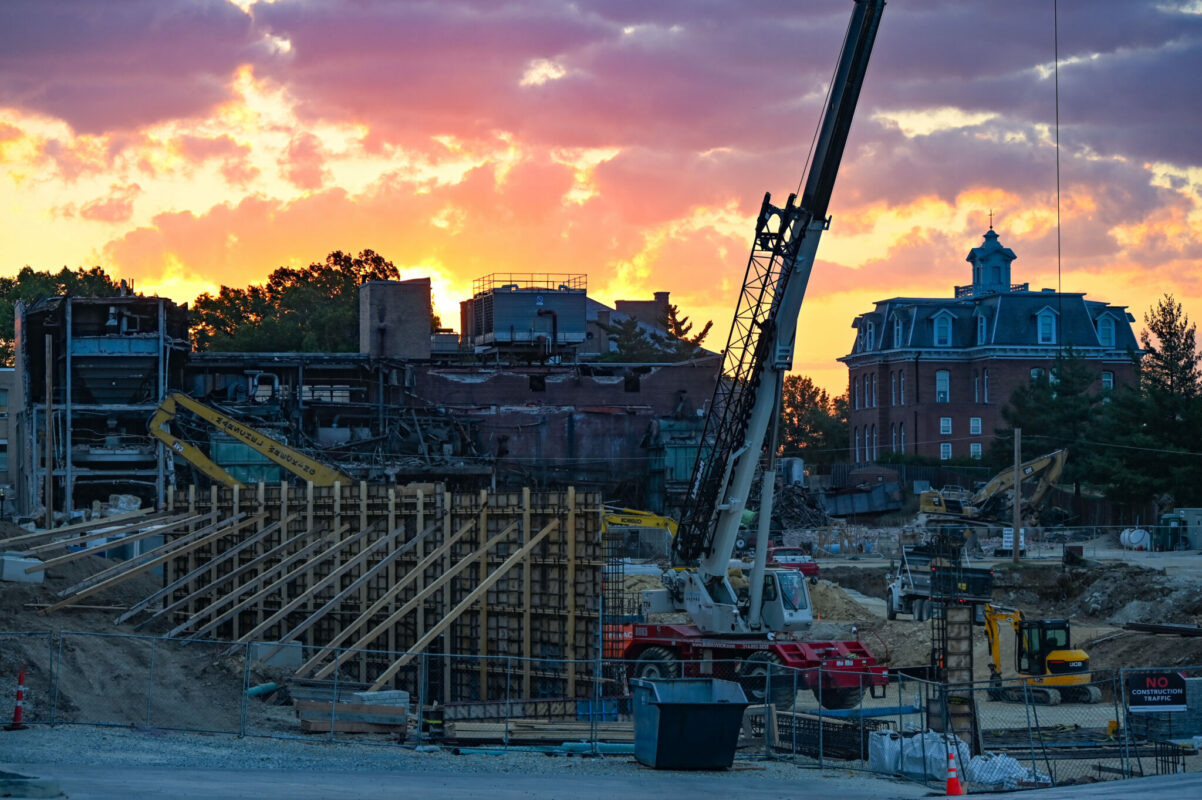 Campus construction with crane at sunrise