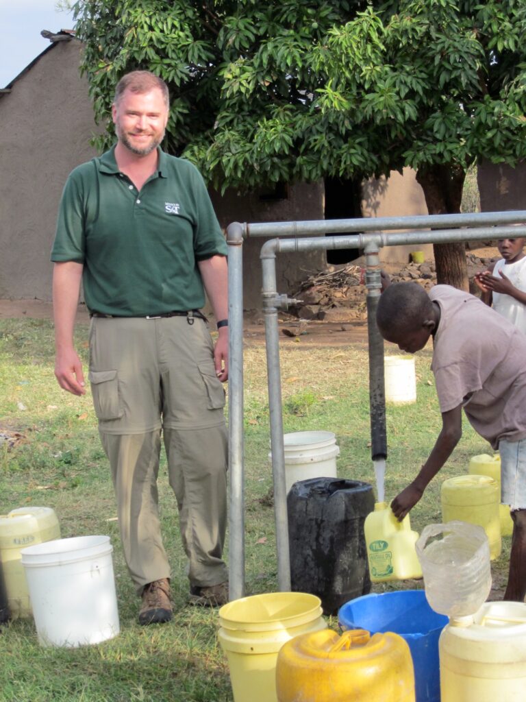 Dr. Daniel Oerther next to a water stand in Otho Abwao, Kenya.