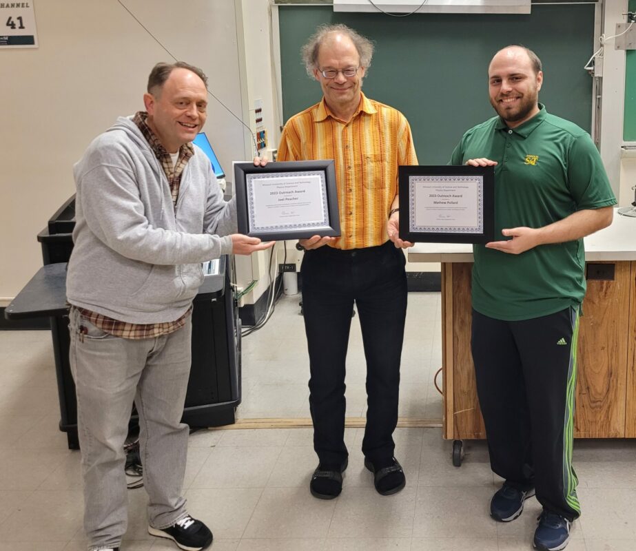 Two men receiving awards from Dr. Thomas Vojta.