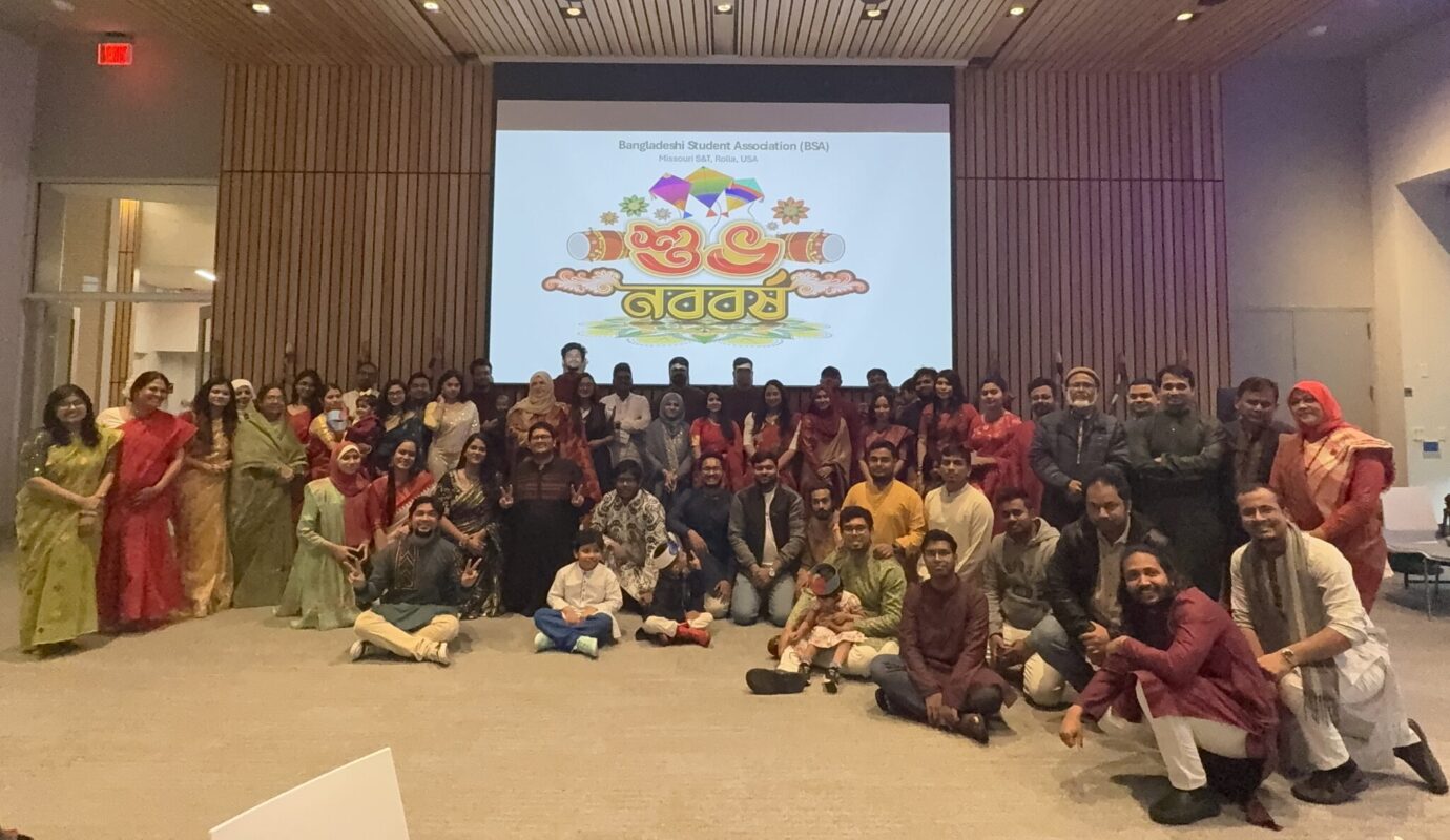 A group of people wearing traditional attire posing for a photo.