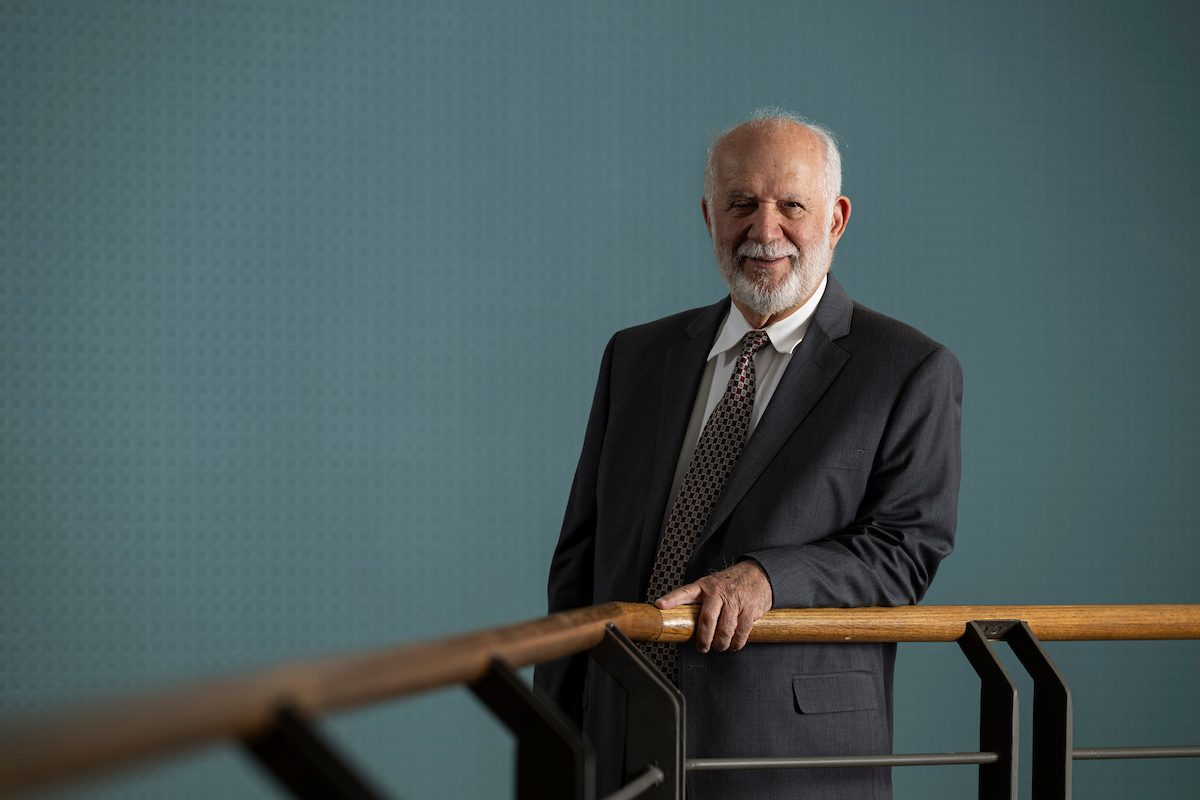 Dr. Cihan Dagli standing near a handrail wearing a suit.