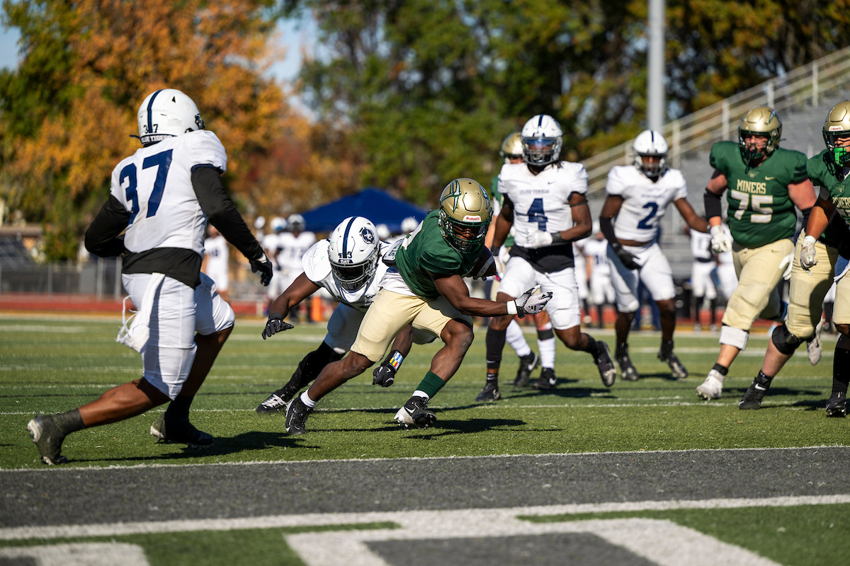 Football players on a football field during a game.