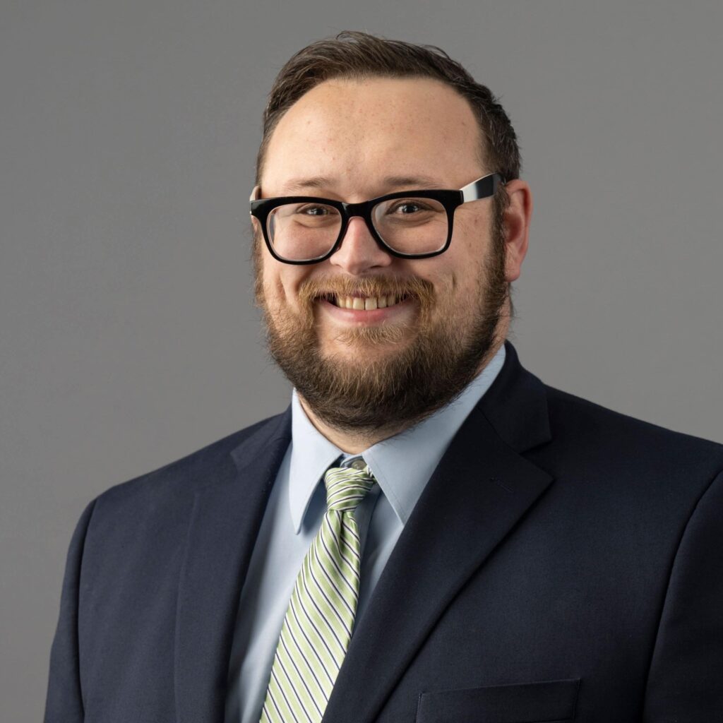 A head shot of Dr. Greg Edwards wearing a suit.