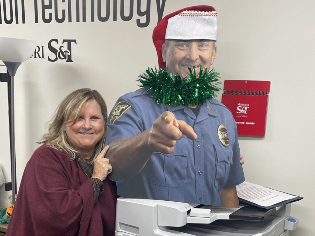 A woman poses with Chief Roberts' cutout.