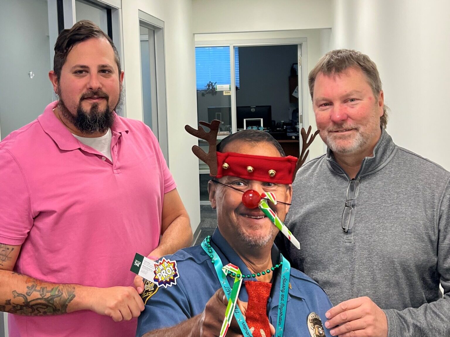 Two men pose with the cardboard cutout of Chief Roberts.