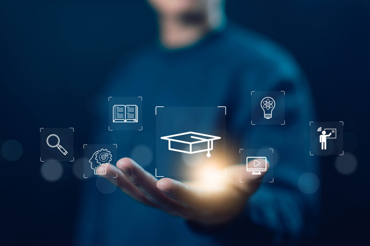 A man has his hand open illuminating several icons including a graduation cap, a light bulb, a magnifying glass, and a book.
