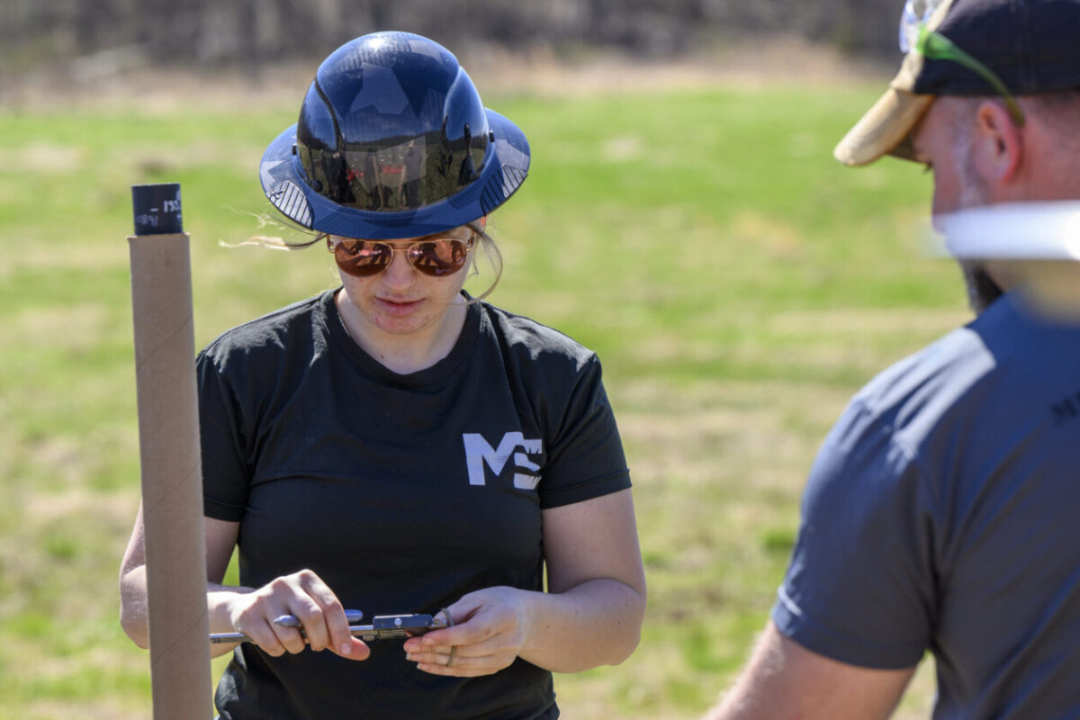 Avery Lyons wears a PPE while working on an explosives experiment.