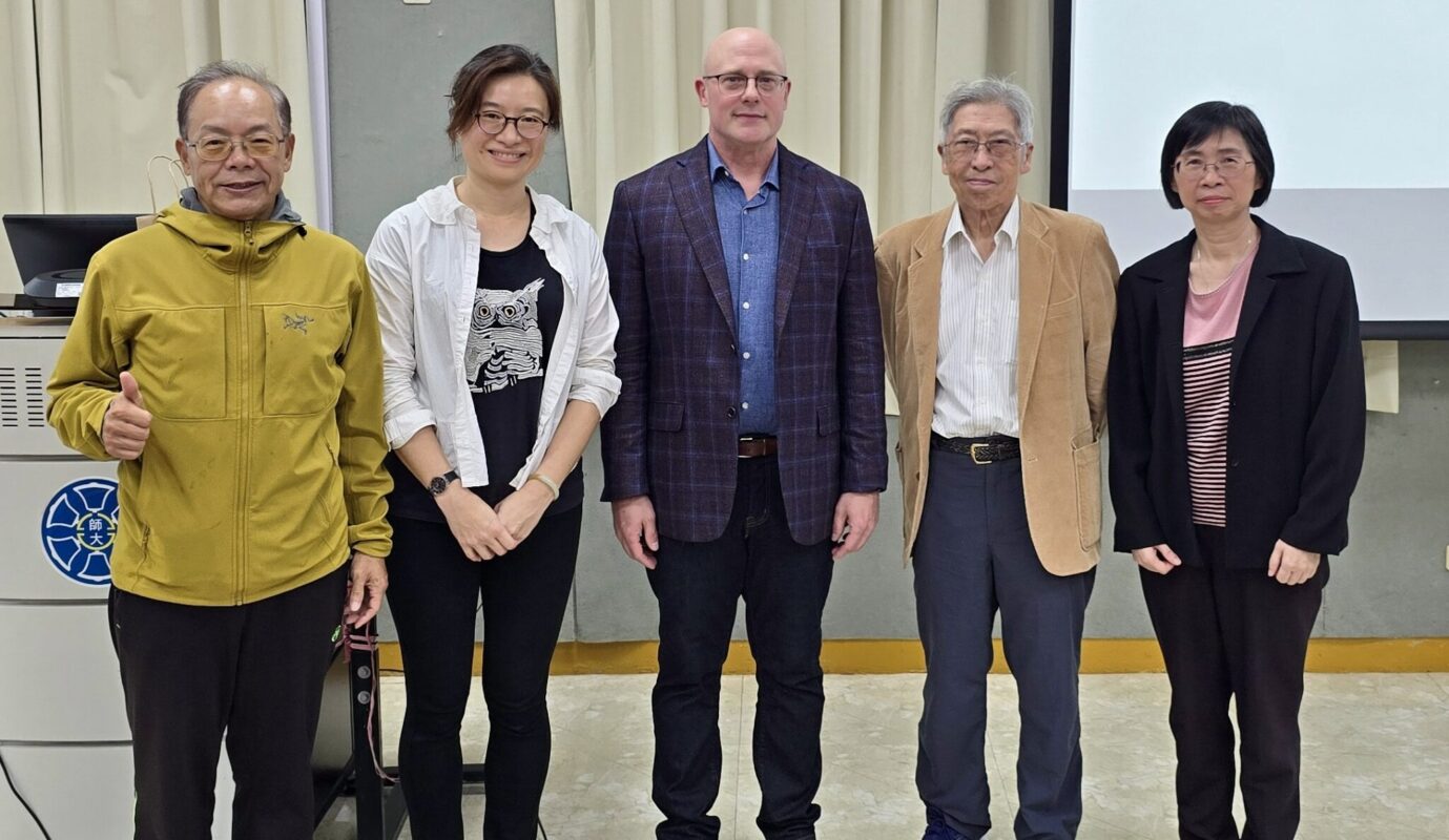 Five people standing for a photo with Dr. Epting in the center.