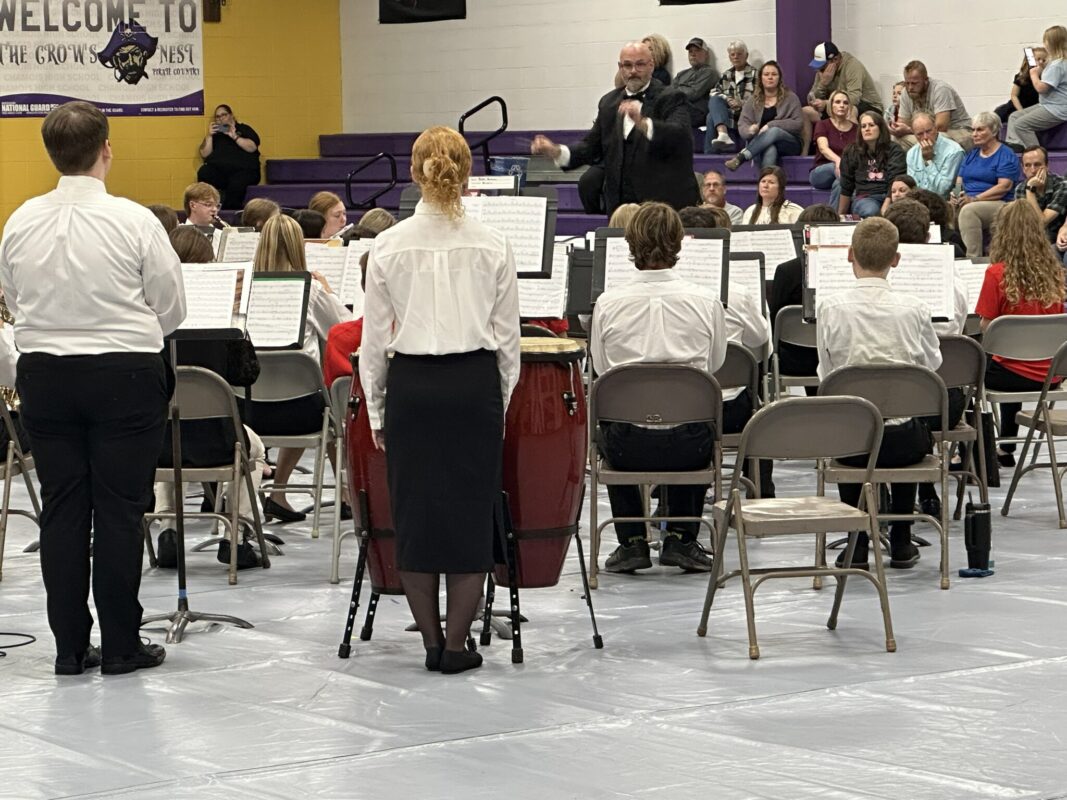 Students seated performing a concert.