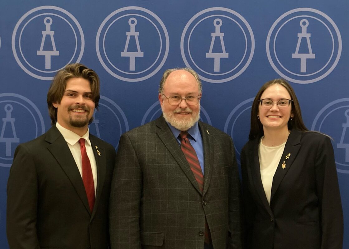 Rylie Miller and Matthew Tierney pose for a photo with Steve Watkins in the middle.