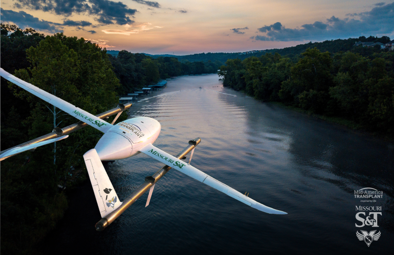 A drone with Missouri S&T stickers flies over a river in the Ozarks.