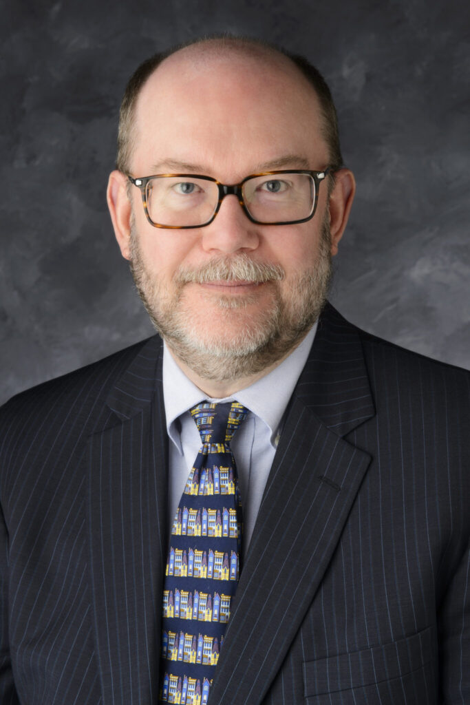 Professional portrait of Dr. Dainel Reed.