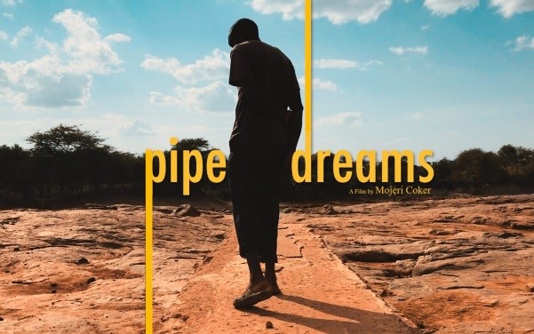 Poster-style image showing a person walking alone on a narrow dirt path through a dry, rocky landscape under a bright sky. Bold yellow text across the center reads “pipe dreams,” with “A Film by Mojeri Coker” written below.
