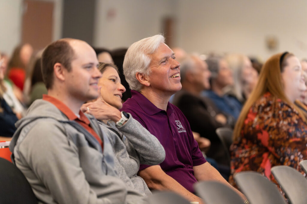 Audience members seated and listening during the Staff Appreciation Day award ceremony.