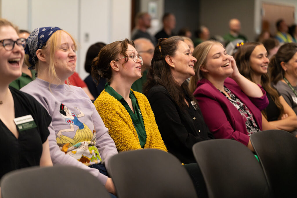 Audience members seated and listening during the Staff Appreciation Day award ceremony.