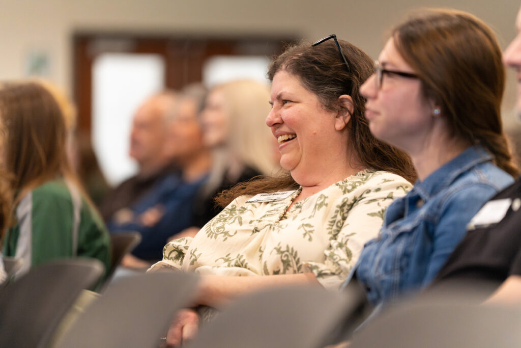 Audience members seated and listening during the Staff Appreciation Day award ceremony.