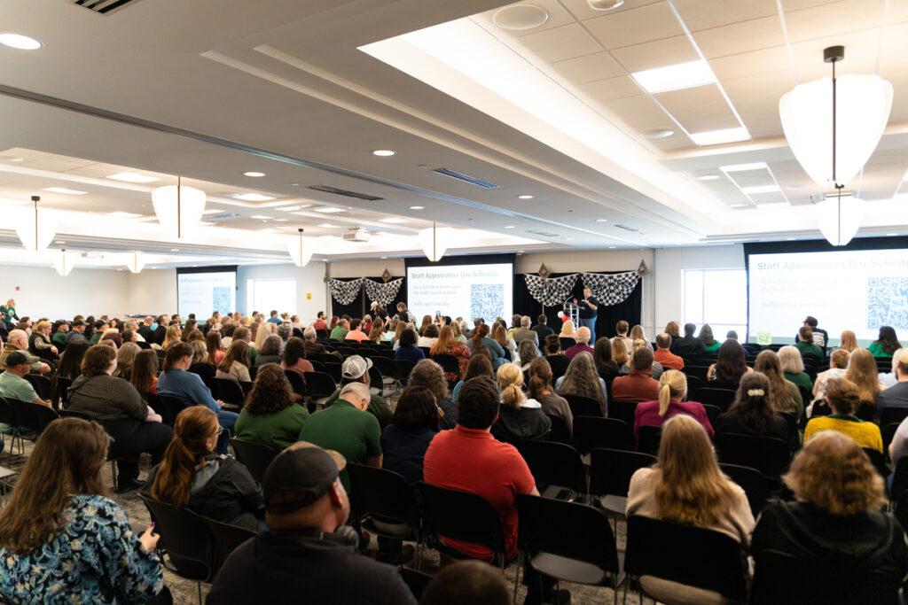 Wide view of a large audience seated and facing a stage during a Missouri S&T staff appreciation event.