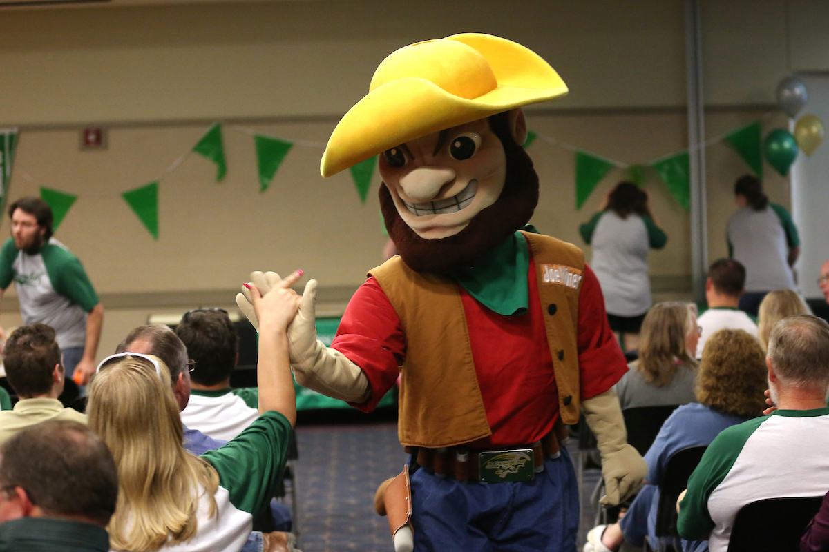 Joe Miner, S&T's mascot, high fives a staff member at a Staff Appreciation Day ceremony.