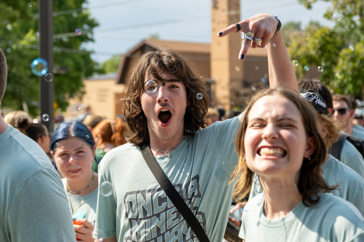 New students show excitement as they arrive at the New Student Convocation event, with bubbles floating through the crowd.