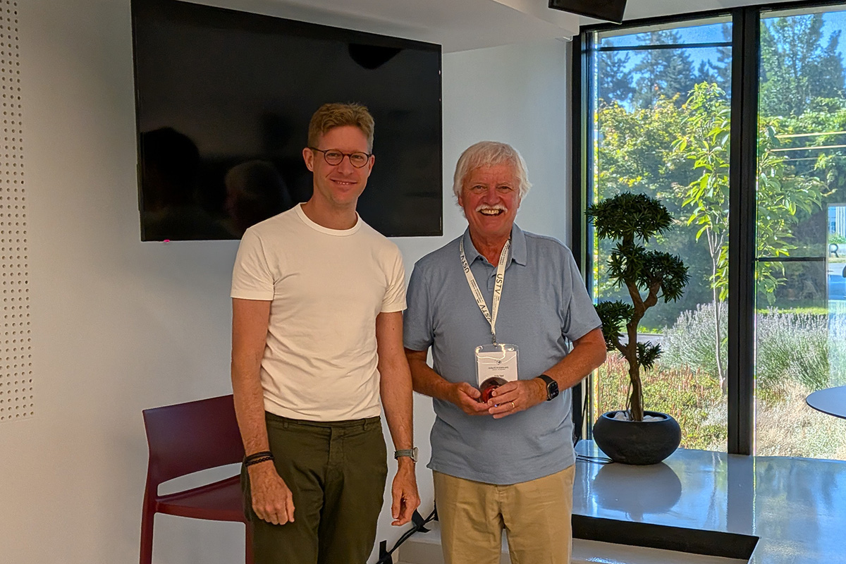 Conference chair Gerald Lelong (left) and Dr. Brow (right) stand together at a conference venue.