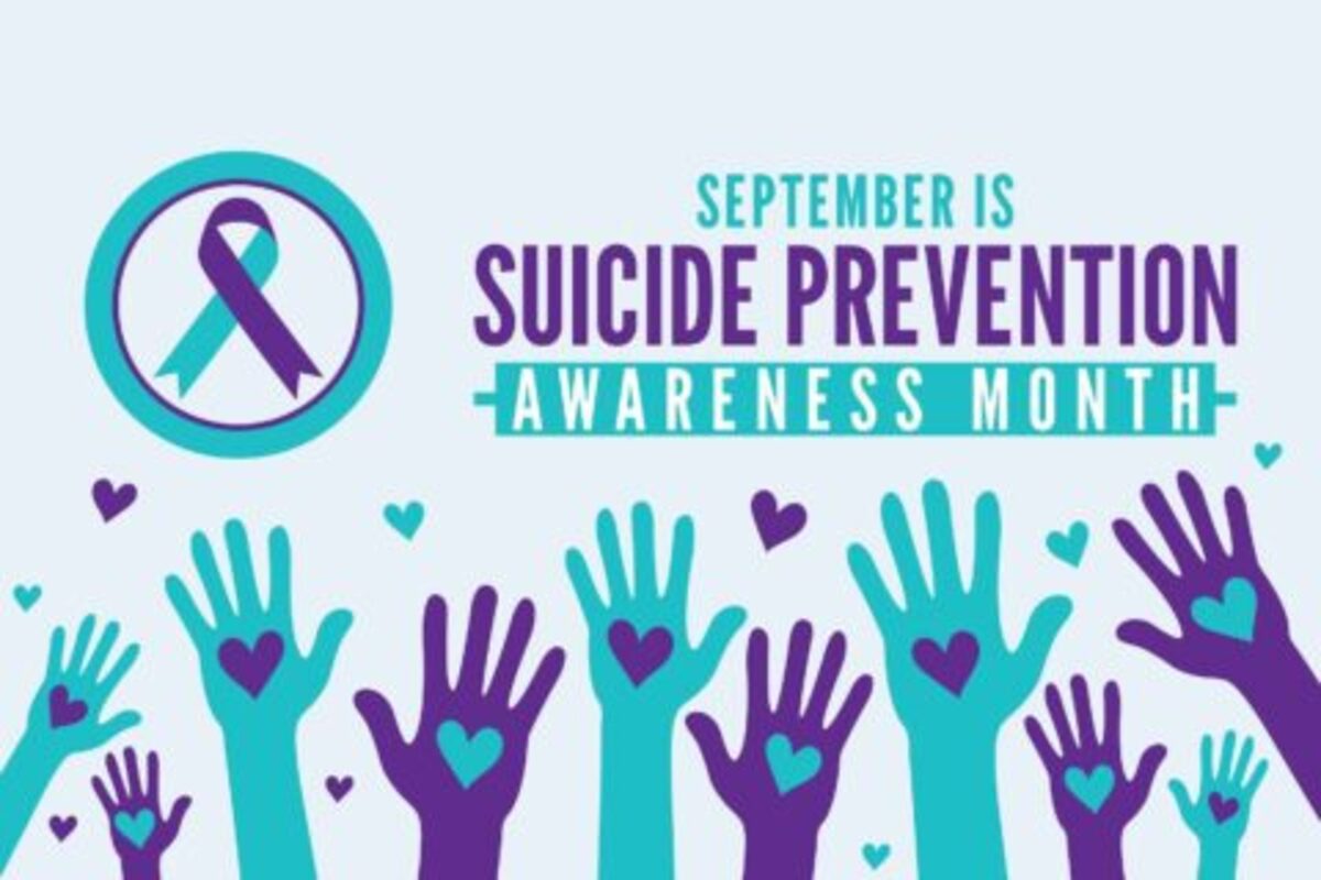 An illustration of teal and purple hands raised with hearts on palms, against a light blue background. To the left is a teal circle with a teal and purple ribbon inside, representing the suicide prevention awareness symbol. Text in the upper right reads "SEPTEMBER IS SUICIDE PREVENTION AWARENESS MONTH" in purple and teal lettering.